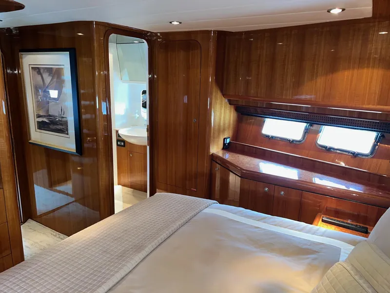 Slide: The Image of Luxurious 2001 Horizon Skylounge yacht interior with wood paneling and cozy bedroom. - 26