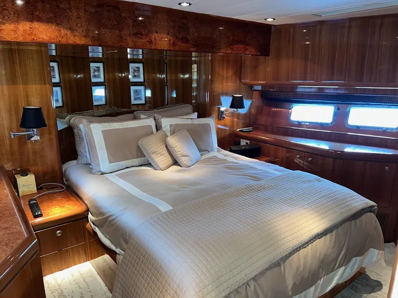 Slide: The Image of Luxurious bedroom in 2001 Horizon Skylounge yacht with elegant wood paneling and plush bedding. - 28