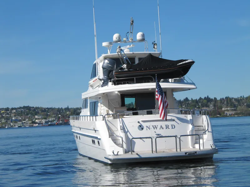 Slide: The Image of Luxury 2001 Horizon Skylounge yacht on calm water, American flag displayed. - 3