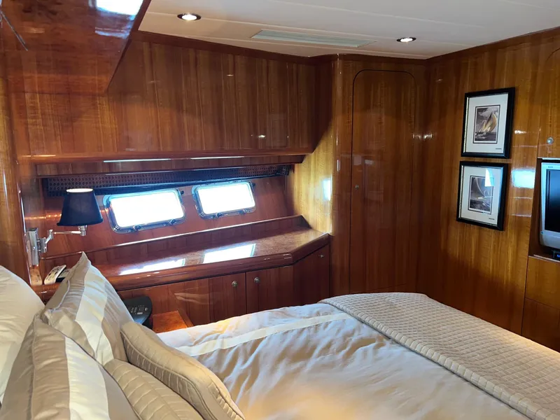 Slide: The Image of Luxurious cabin interior of 2001 Horizon Skylounge yacht with wood paneling and cozy bedding. - 30