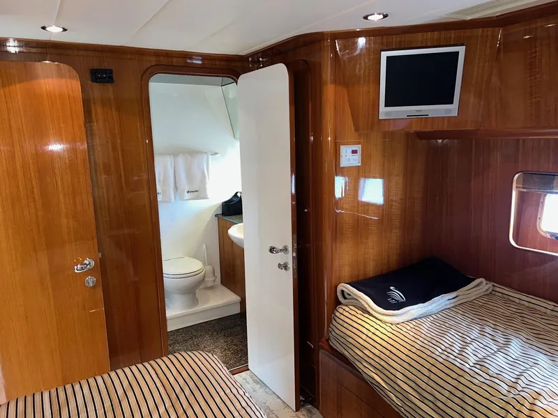 Slide: The Image of Luxurious 2001 Horizon Skylounge yacht cabin with wooden interior, twin beds, and ensuite bathroom. - 34