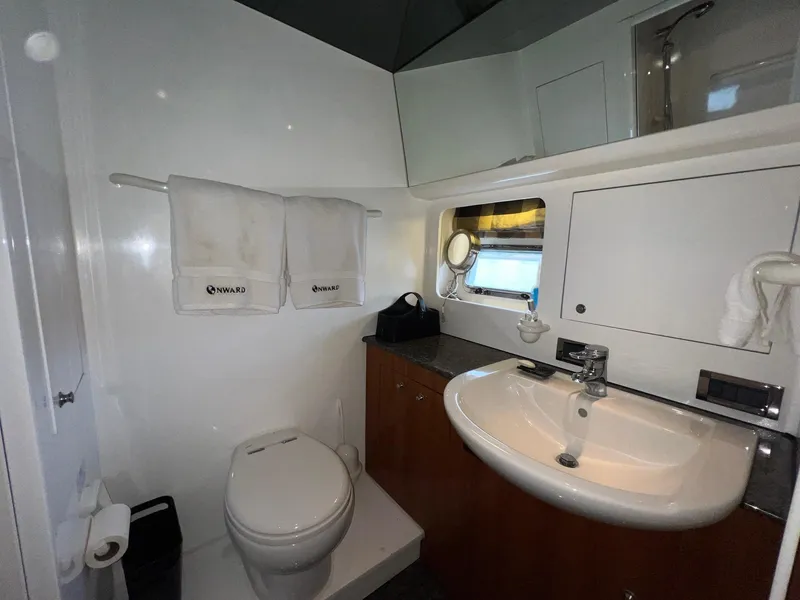 Slide: The Image of Bathroom interior of 2001 Horizon Skylounge yacht with sink, toilet, and towels. - 35