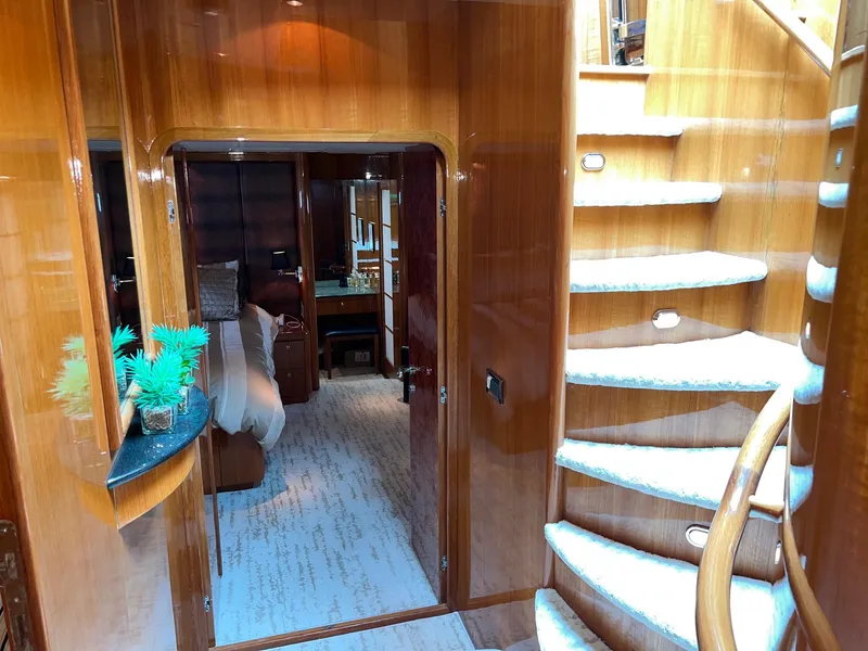 Slide: The Image of Luxurious interior of 2001 Horizon Skylounge yacht with elegant wood paneling and spiral staircase. - 36