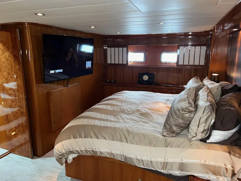 Slide: The Image of Luxurious bedroom in 2001 Horizon Skylounge yacht with wood paneling and mounted TV. - 38