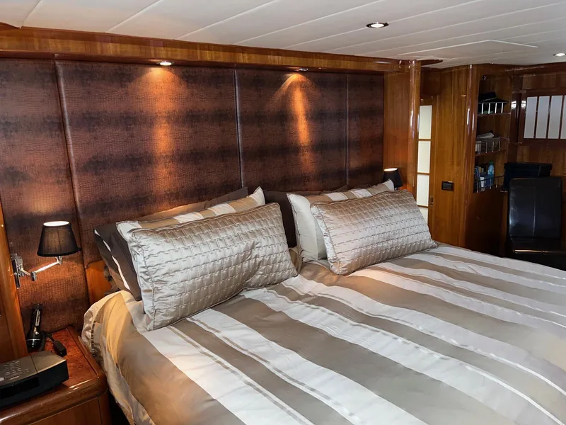 Slide: The Image of Luxurious bedroom interior on 2001 Horizon Skylounge yacht with elegant bedding and wood paneling. - 43