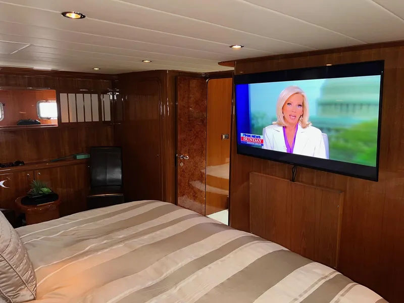 Slide: The Image of Luxurious 2001 Horizon Skylounge yacht bedroom with TV and elegant wood paneling. - 44