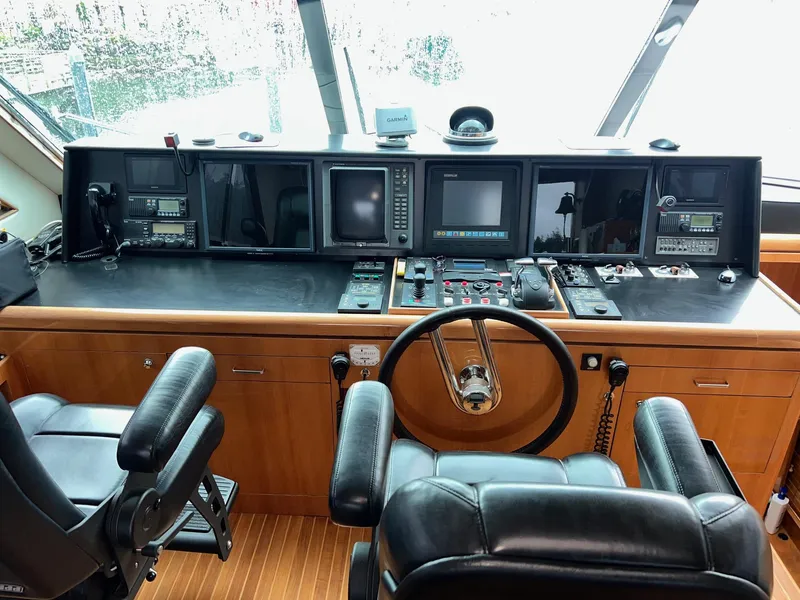 Slide: The Image of Pilothouse of 2001 Horizon Skylounge yacht with navigation equipment and leather seating. - 48