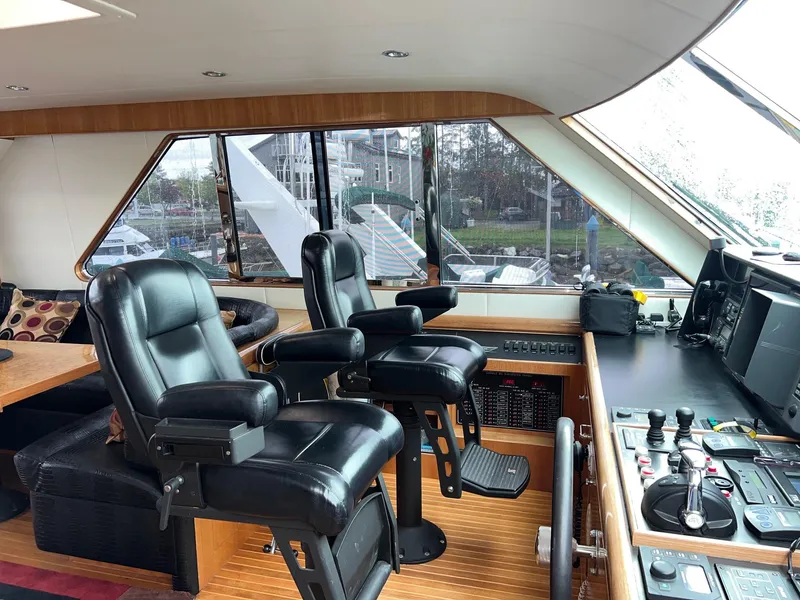 Slide: The Image of Luxurious 2001 Horizon Skylounge yacht interior with leather captain chairs and control panel. - 49