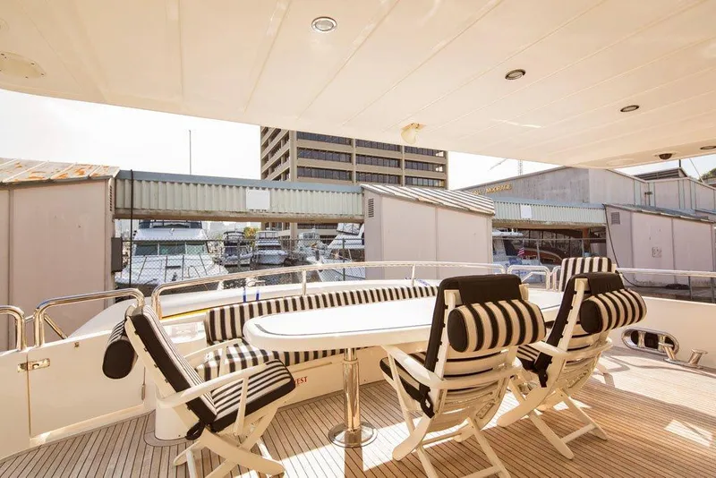 Slide: The Image of Outdoor seating area on 2001 Horizon Skylounge yacht with striped cushions. - 5