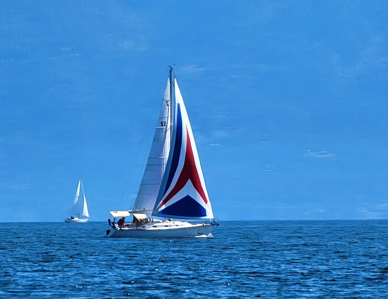 Slide: The Image of Sailboat Tartan 3400 (2007) with colorful spinnaker on open sea. - 0
