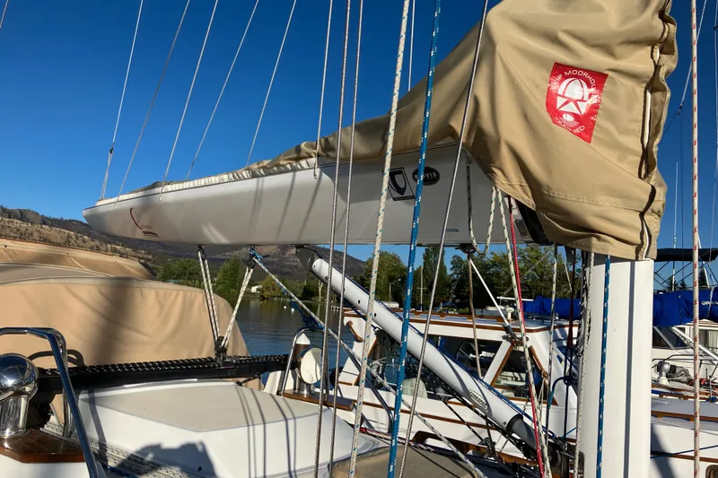 Slide: The Image of Sailboat Tartan 3400, 2007 model, with beige sail cover and rigging, docked under clear sky. - 11