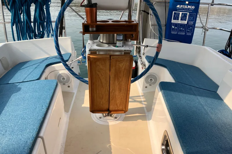 Slide: The Image of Cockpit of 2007 Tartan 3400 sailboat with blue cushions and wooden helm. - 15