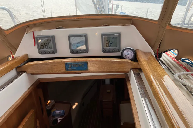 Slide: The Image of 2007 Tartan 3400 yacht cockpit with navigation instruments and wooden finish. - 16