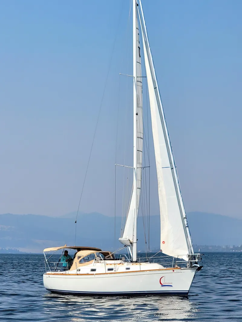 Slide: The Image of Sailboat Tartan 3400, 2007 model, cruising on calm waters under clear skies. - 2
