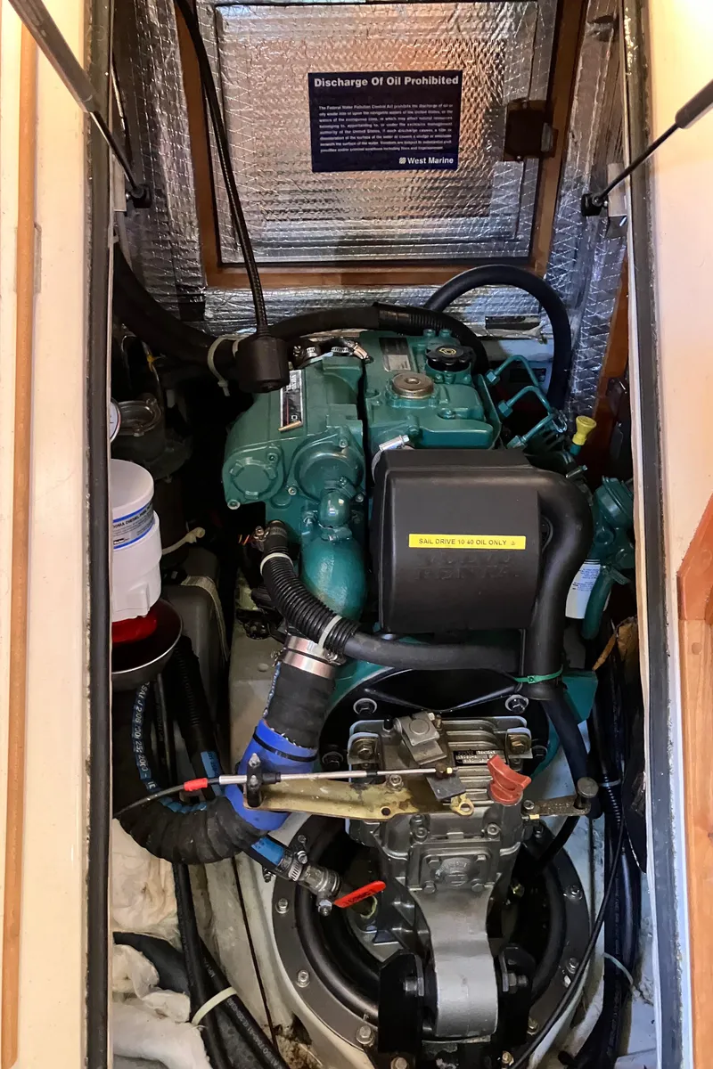 Slide: The Image of Engine compartment of a 2007 Tartan 3400 sailboat, featuring a well-maintained marine engine. - 25