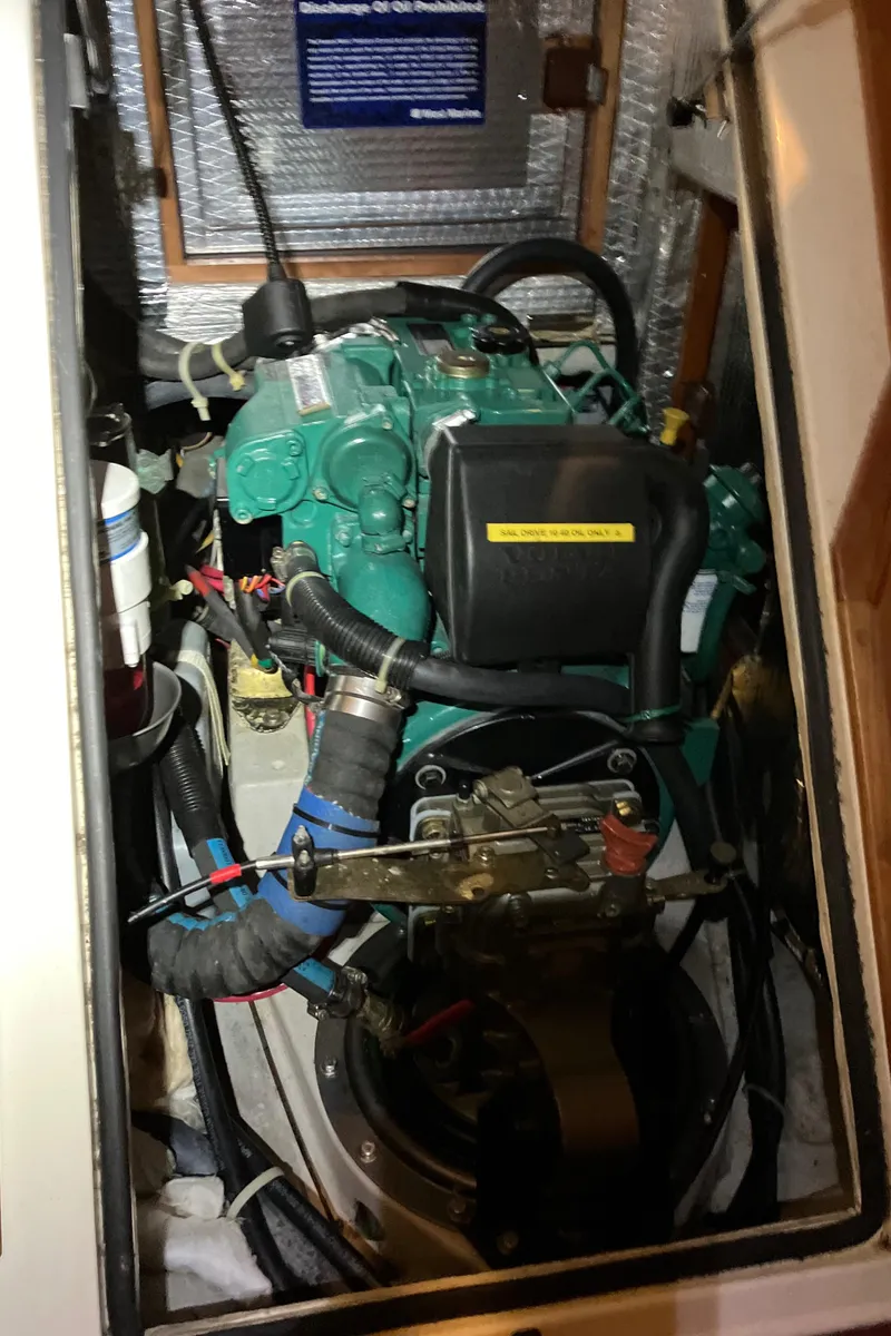 Slide: The Image of Engine compartment of a 2007 Tartan 3400 sailboat, featuring a well-maintained marine engine. - 26