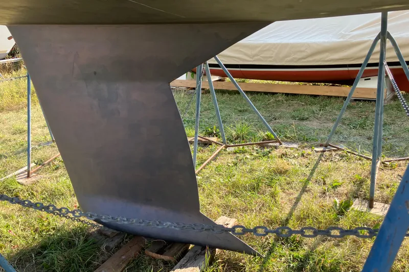 Slide: The Image of Keel of a 2007 Tartan 3400 sailboat on a stand outdoors. - 28