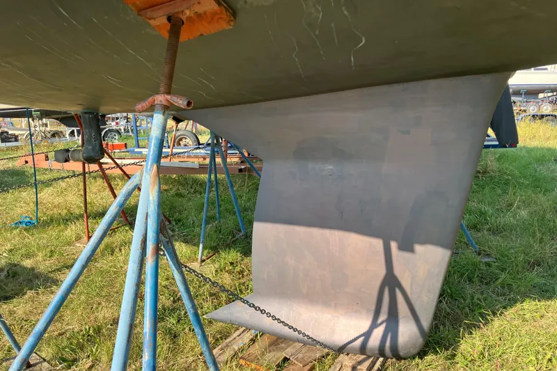 Slide: The Image of Keel of a 2007 Tartan 3400 sailboat supported by stands on grass. - 29