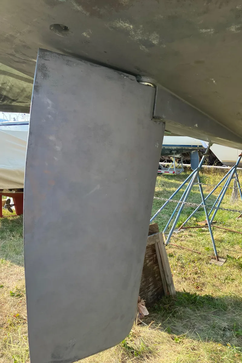 Slide: The Image of Rudder of 2007 Tartan 3400 sailboat on dry dock, with support stands visible. - 31