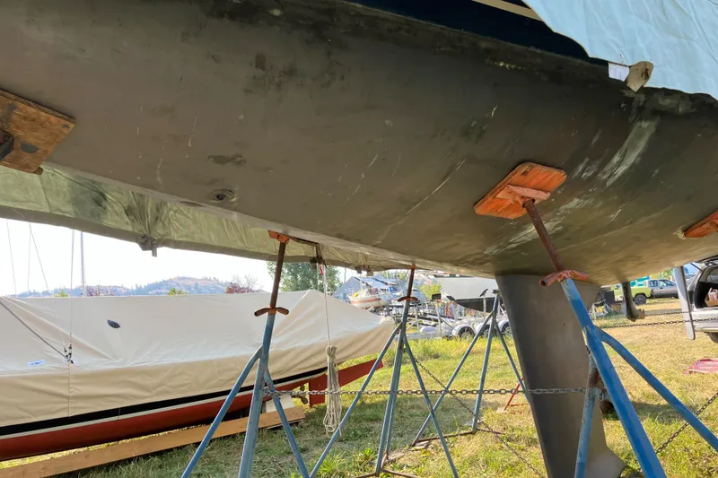 Slide: The Image of 2007 Tartan 3400 sailboat hull on stands, outdoor storage setting. - 32