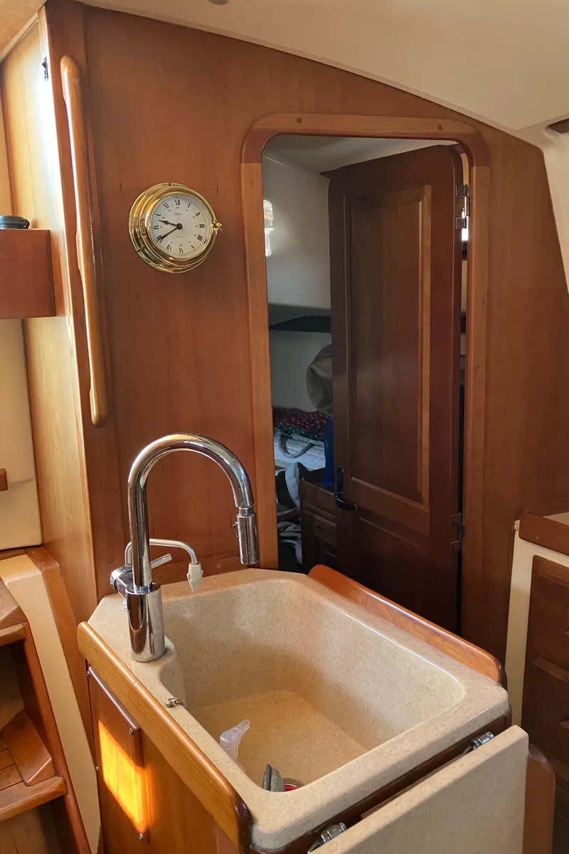 Slide: The Image of Interior of 2007 Tartan 3400 sailboat with sink and wooden cabinetry. - 38