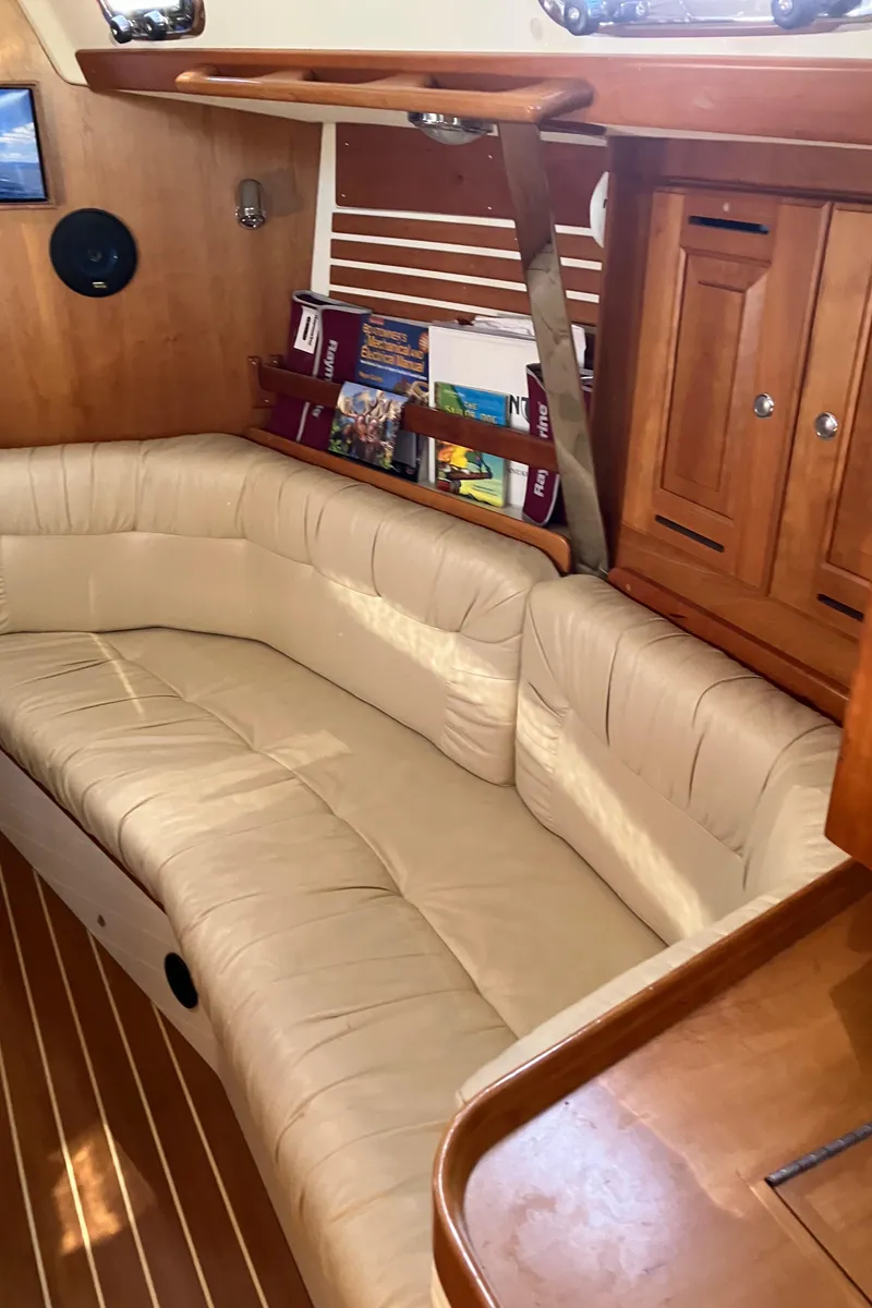 Slide: The Image of Interior of a 2007 Tartan 3400 sailboat with beige seating and wooden cabinetry. - 41