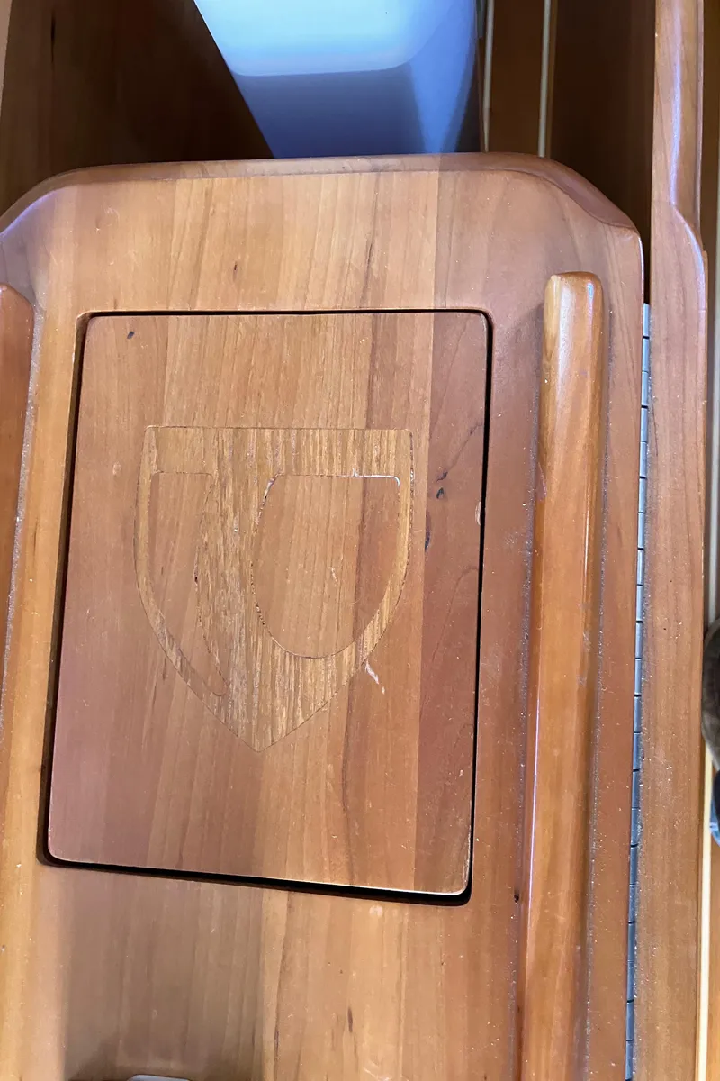 Slide: The Image of Wooden panel with engraved shield emblem on a 2007 Tartan 3400 boat. - 48