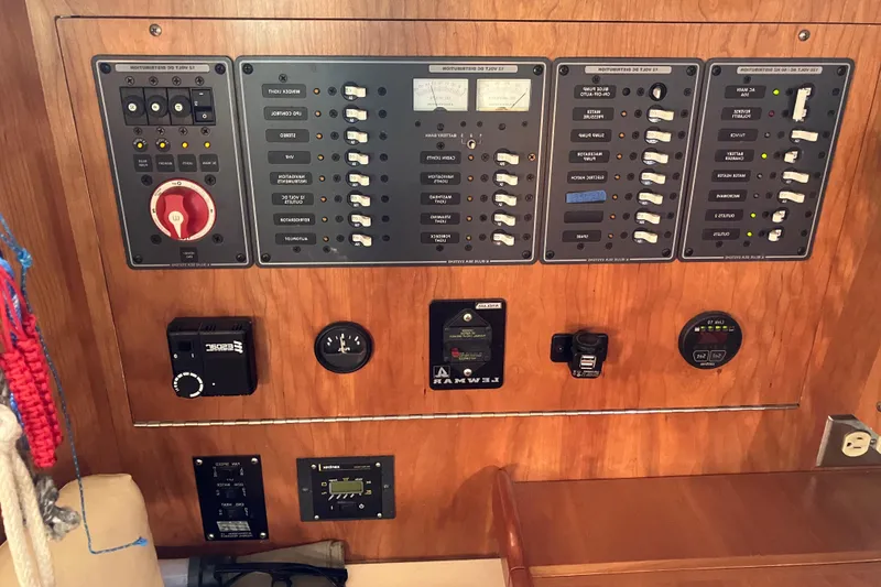 Slide: The Image of Control panel of a 2007 Tartan 3400 yacht with various switches and gauges. - 49