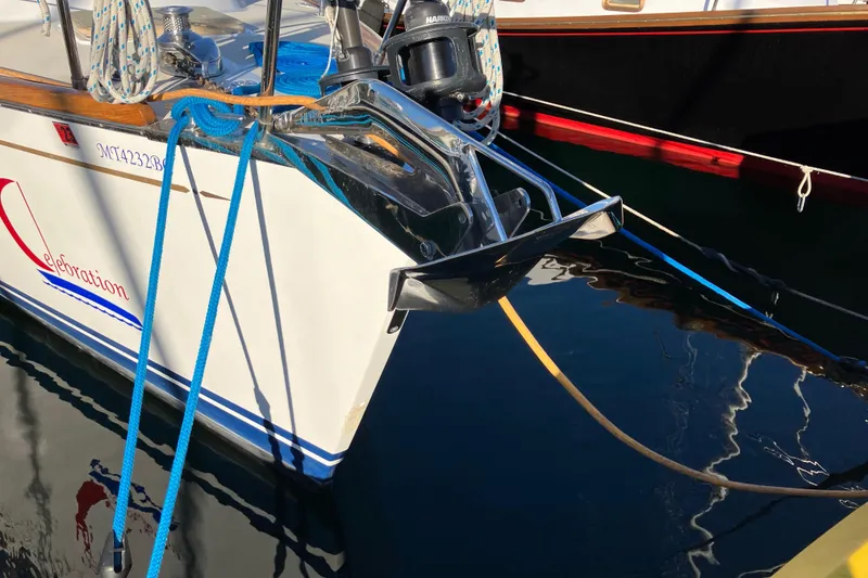 Slide: The Image of Sailboat Tartan 3400 (2007) anchored at marina with blue and yellow ropes. - 8