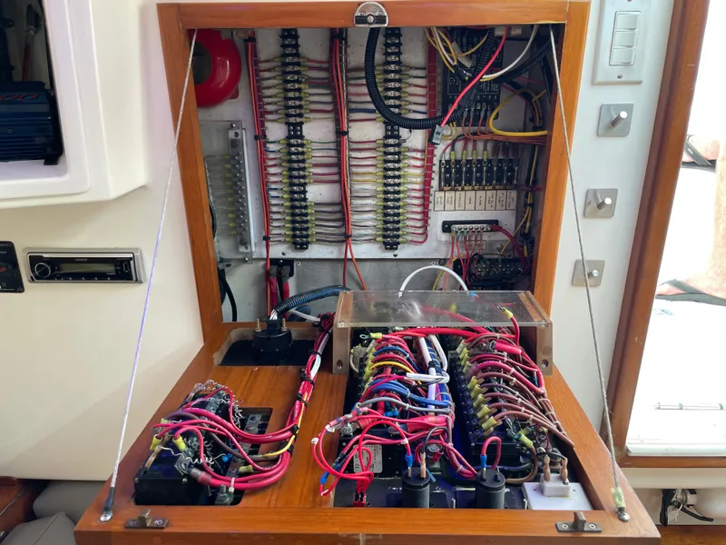 Slide: The Image of Electrical panel of a 1997 Cabo 31 Express boat with organized wiring and components. - 23