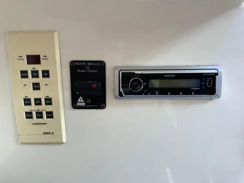 Slide: The Image of Control panel and Kenwood stereo on a 1997 Cabo 31 Express boat. - 25