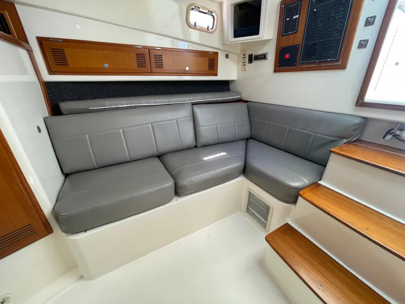Slide: The Image of 1997 Cabo 31 Express interior with gray leather seating and wooden accents. - 27