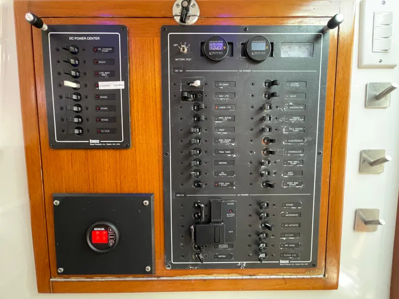 Slide: The Image of Electrical control panel on a 1997 Cabo 31 Express boat, featuring switches and gauges. - 29