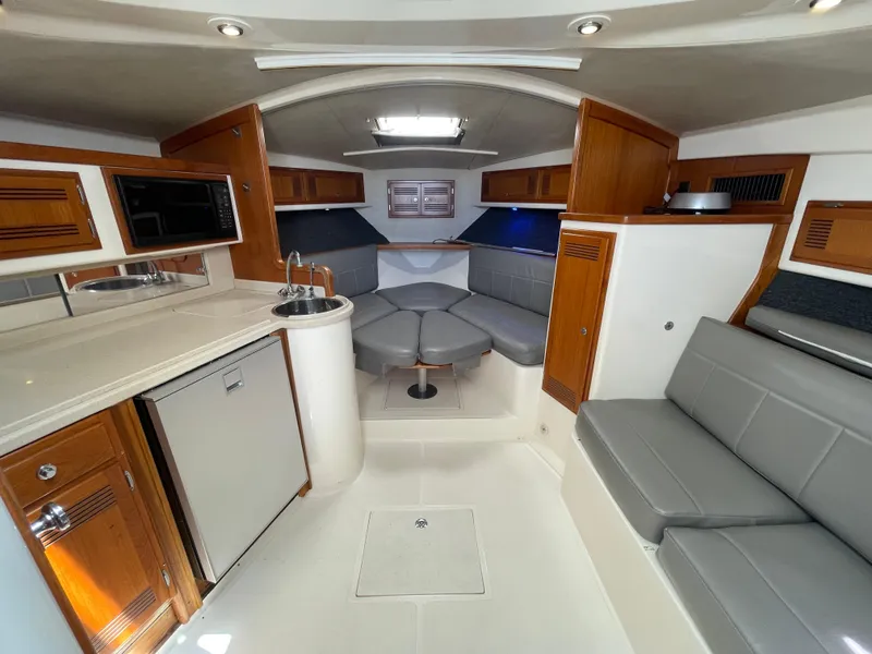 Slide: The Image of Interior of a 1997 Cabo 31 Express boat with modern amenities and seating. - 32