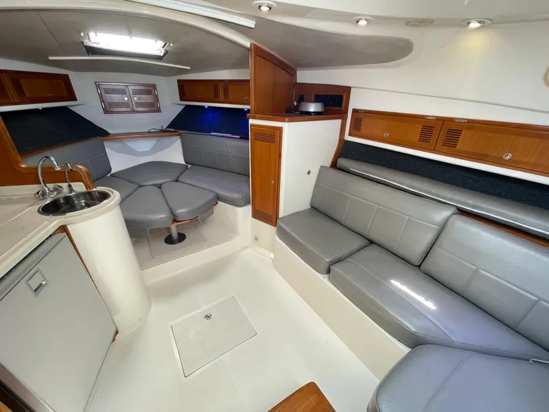 Slide: The Image of Luxurious interior of a 1997 Cabo 31 Express boat with seating and kitchenette. - 34