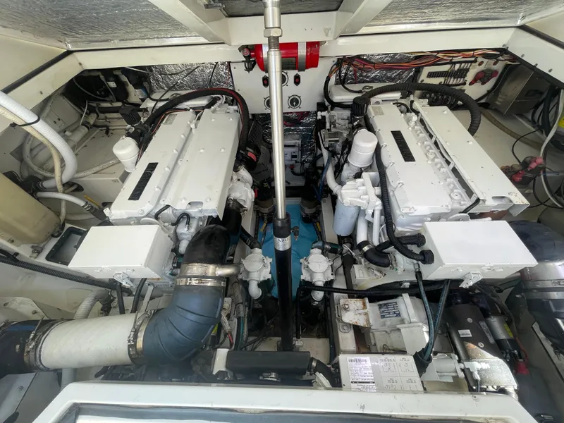 Slide: The Image of Engine room of a 1997 Cabo 31 Express boat, showcasing dual engines and mechanical components. - 36