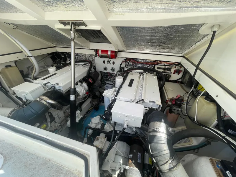 Slide: The Image of Engine room of a 1997 Cabo 31 Express boat, showcasing dual engines and mechanical components. - 37