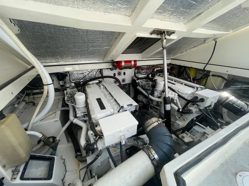 Slide: The Image of Engine room of a 1997 Cabo 31 Express boat, showcasing dual engines and mechanical components. - 38