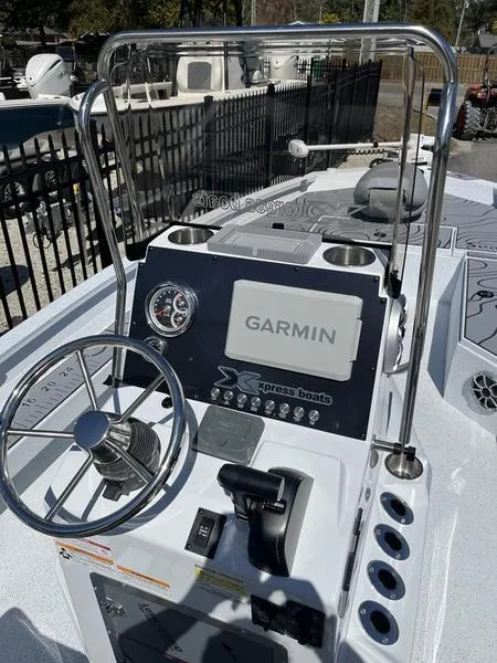 Slide: The Image of 2025 Xpress H22B boat console with Garmin navigation system and steering wheel. - 11