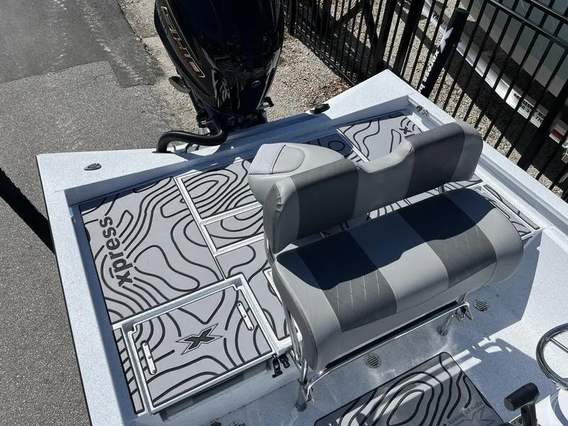 Slide: The Image of 2025 Xpress H22B boat interior with patterned flooring and dual seating. - 13