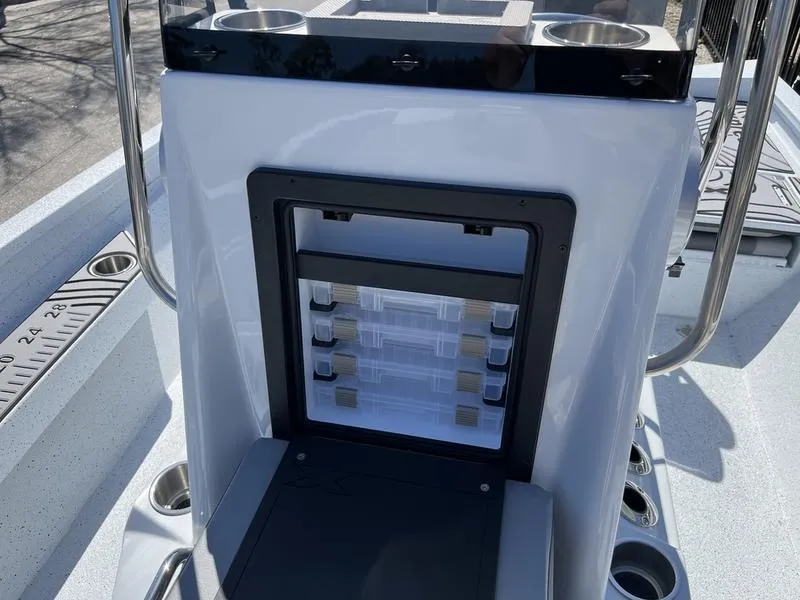 Slide: The Image of 2025 Xpress H22B boat console with storage compartments and cup holders. - 9