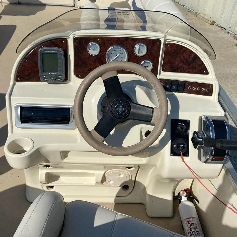Slide: The Image of Steering console of 2008 Godfrey Sweetwater SWT 2486 FC boat with gauges and controls. - 5