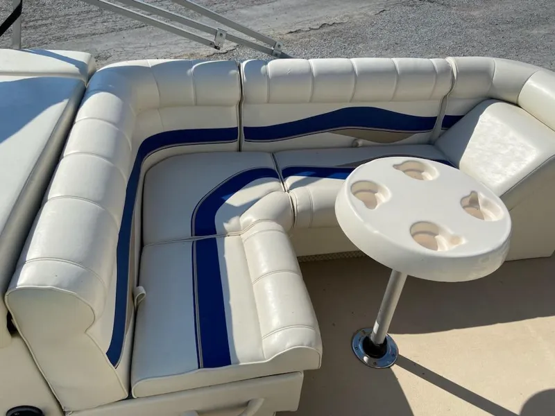 Slide: The Image of 2008 Godfrey Sweetwater SWT 2486 FC boat seating with white and blue upholstery and cup holder table. - 6