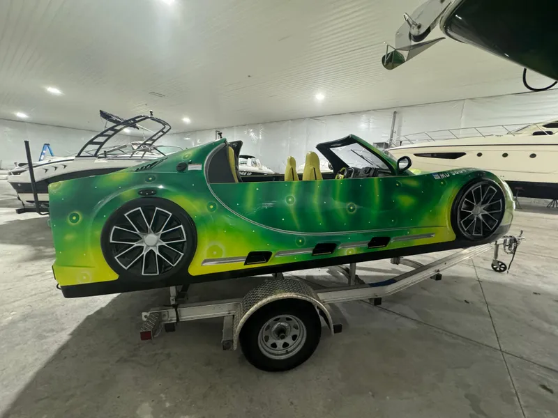 Slide: The Image of 2023 Watersports Car Series B in vibrant green, displayed on a trailer indoors. - 4