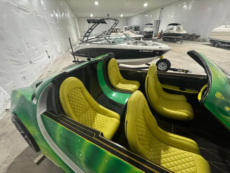 Slide: The Image of 2023 Watersports Car Series B with vibrant yellow seats in a showroom. - 7