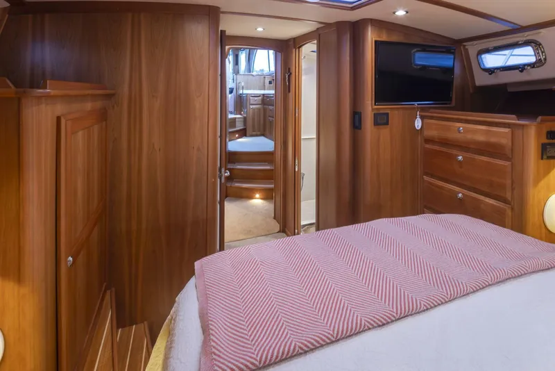 Slide: The Image of Luxurious interior of 2018 Sabre 45 Salon Express yacht with wood finish and cozy bedding. - 11