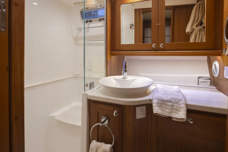 Slide: The Image of Luxurious bathroom in 2018 Sabre 45 Salon Express yacht with modern fixtures and wooden cabinetry. - 12