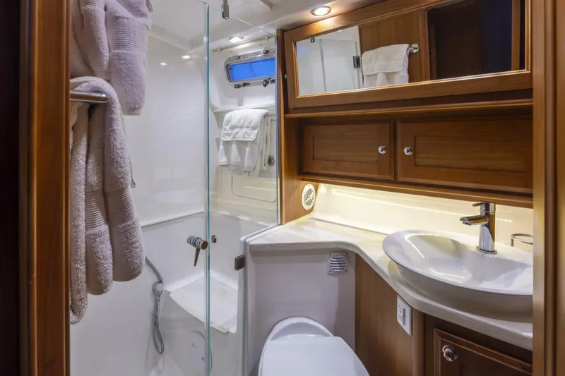 Slide: The Image of Luxurious bathroom in 2018 Sabre 45 Salon Express yacht with wood cabinetry and modern fixtures. - 14