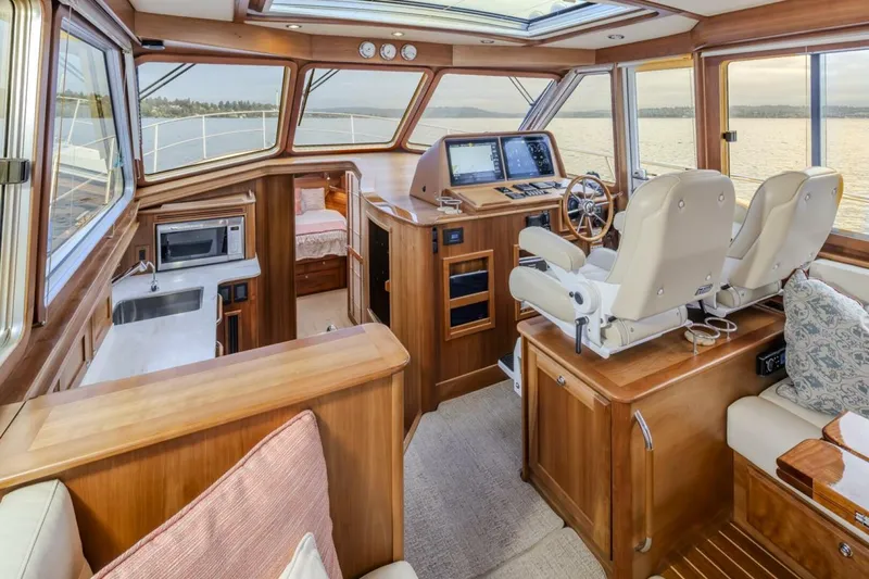 Slide: The Image of Interior of 2018 Sabre 45 Salon Express yacht with helm, seating, and kitchenette. - 19