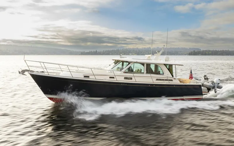 Slide: The Image of 2018 Sabre 45 Salon Express cruising on open water under a cloudy sky. - 2